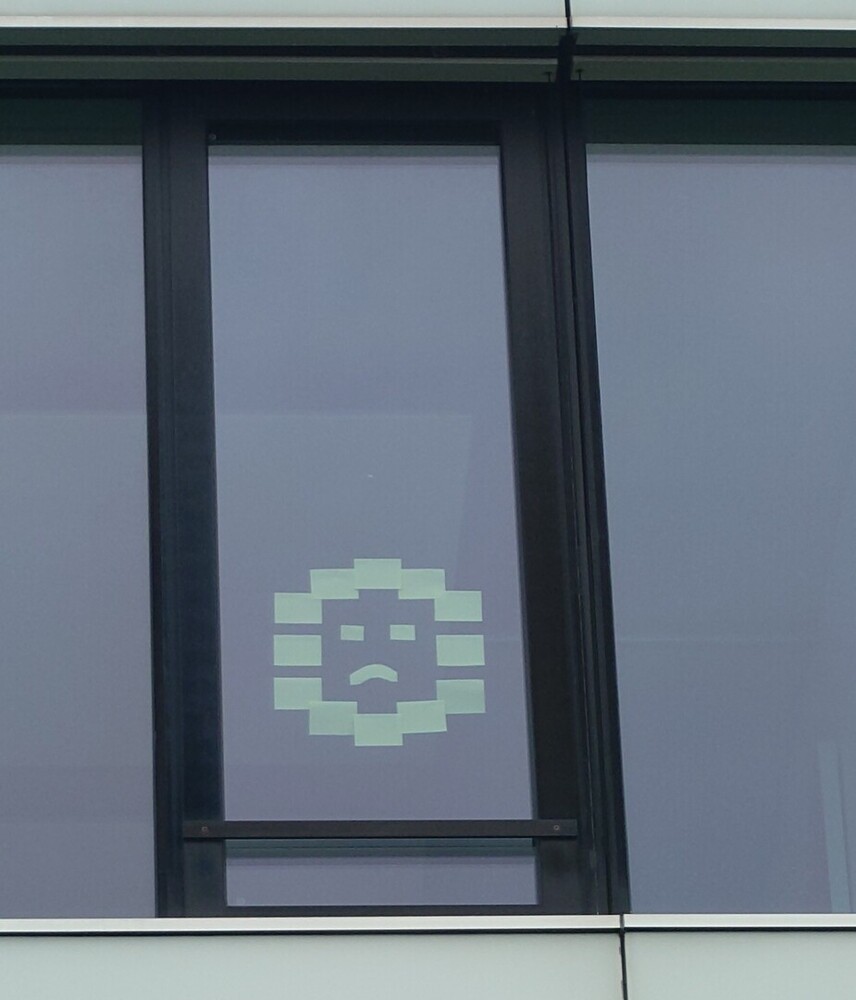 Photograph of post-it's arranged as a sad face