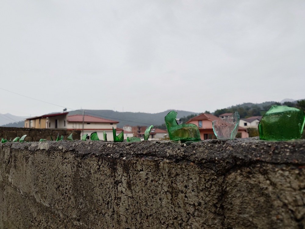 Broken glass bottles on a wall
